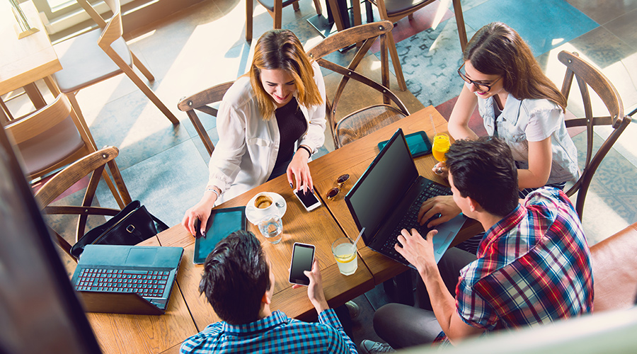 young adults sitting around table